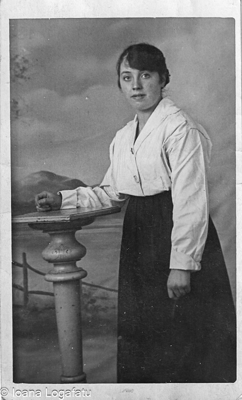 Young woman in vintage attire by a pillar
