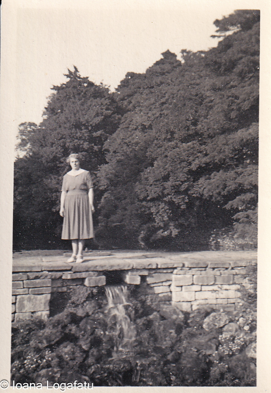 Woman standing gracefully by a serene waterfall