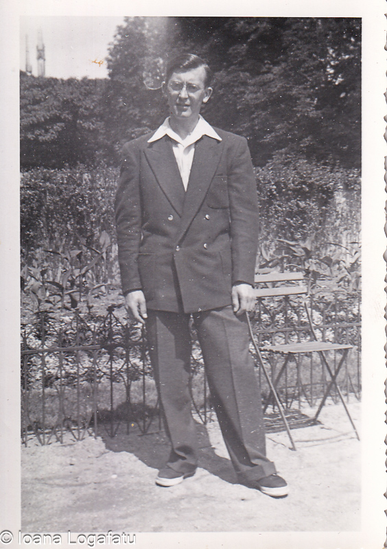 Man in stylish outfit standing near garden chair