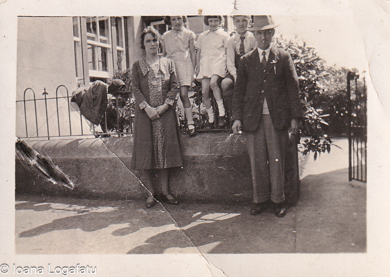 Family gathering in front of a vintage home