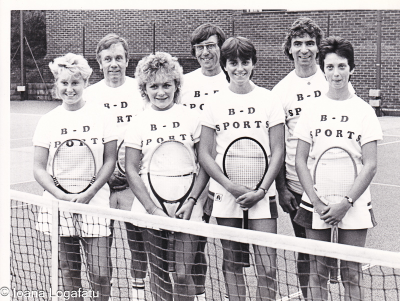 Tennis team posing with pride on the court