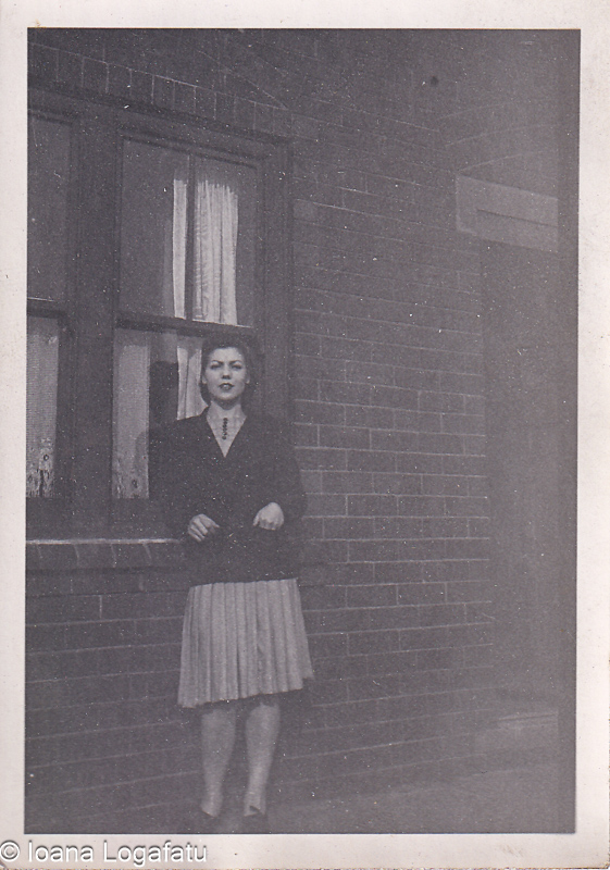 Vintage portrait of a woman by a brick wall