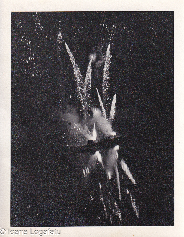 Fireworks light up the night sky over calm waters