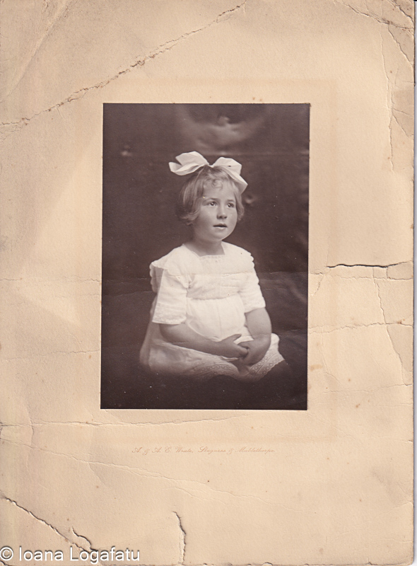 Portrait of a young girl with a bow in her hair