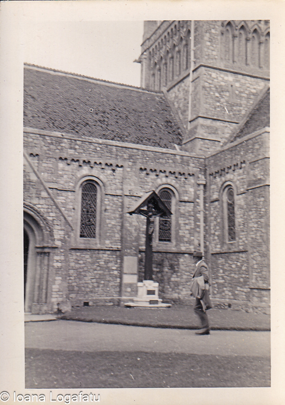 Walking past a historic church building in the sun