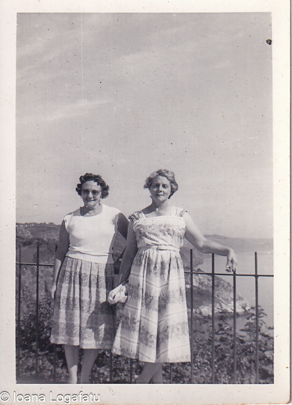Two friends enjoy a sunny day by the coast