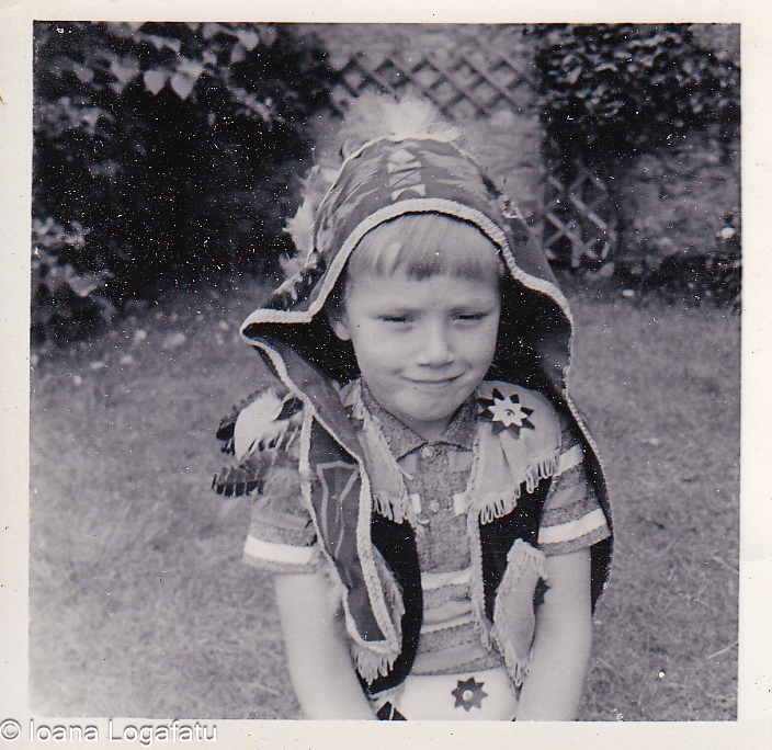 Young boy dressed in traditional attire outdoors