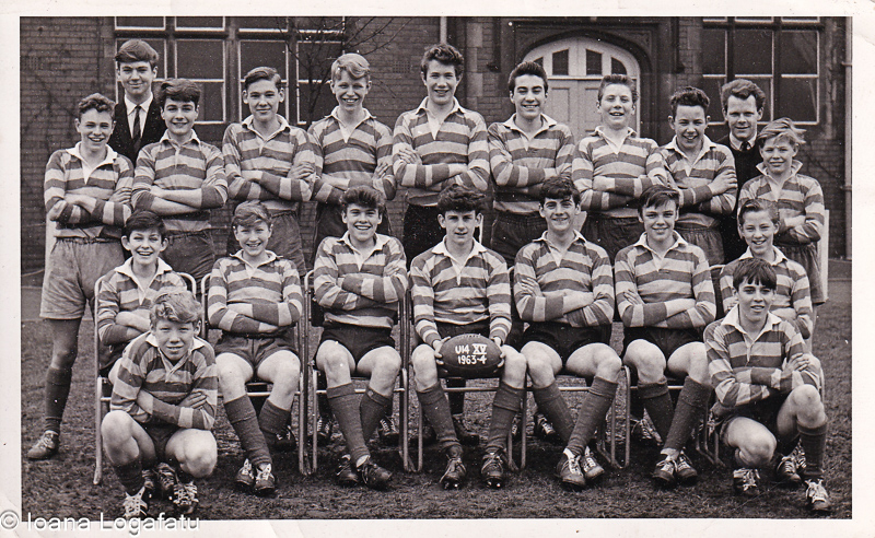 Young rugby players pose proudly at school field