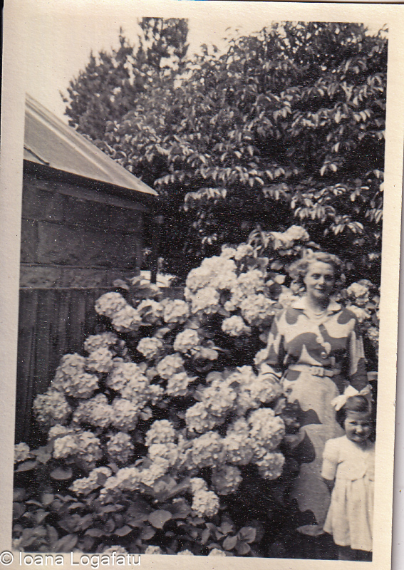 Woman and girl by spring hydrangeas