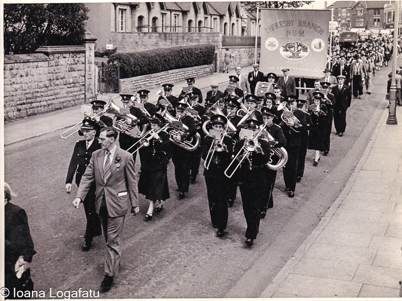 Marching band parades through city streets