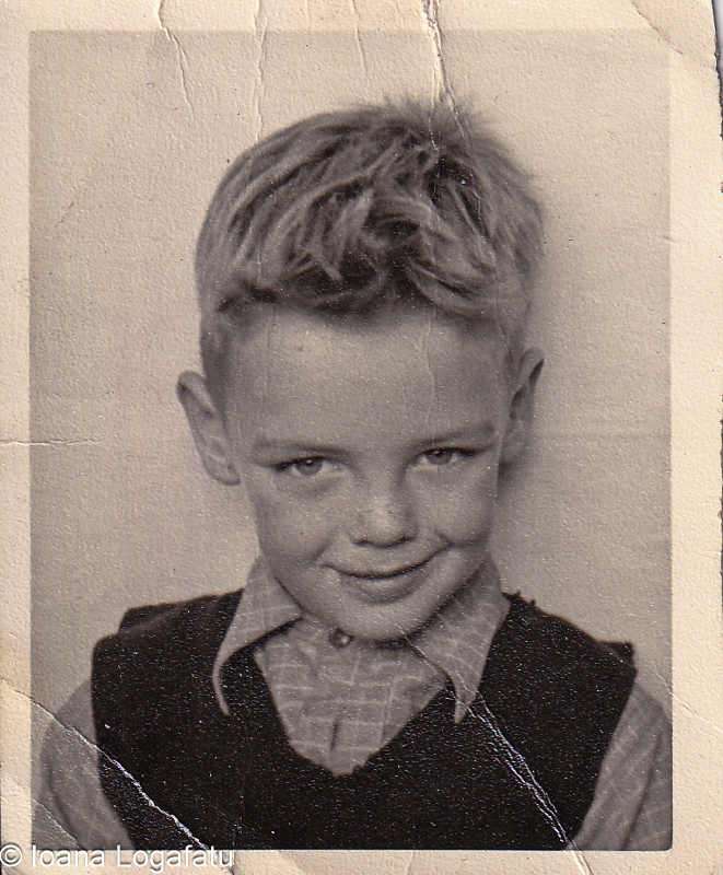 Smiling boy poses for vintage photo