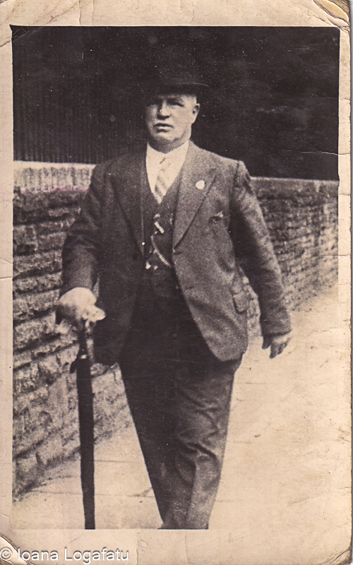 Man walking with an umbrella in vintage attire