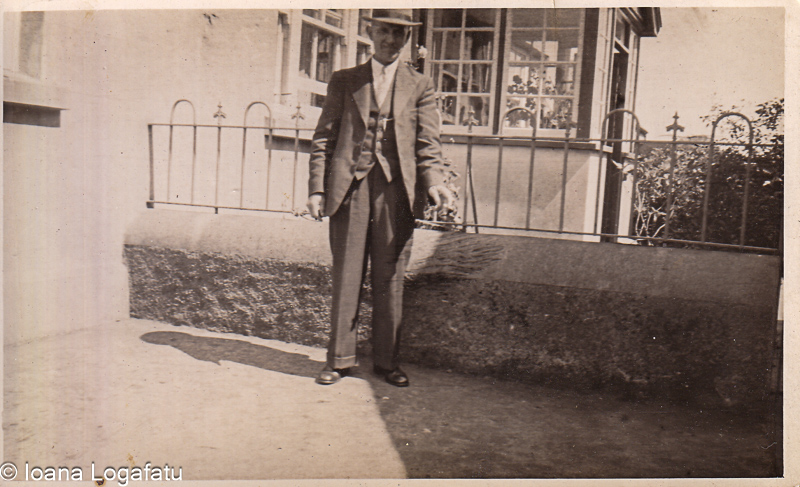 Man sweeping outside a rustic building