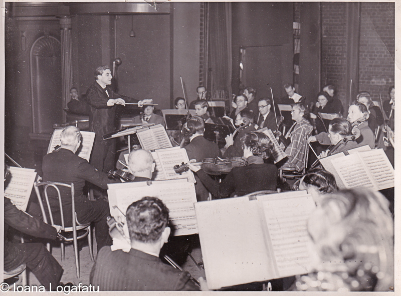 Orchestra plays under conductor's guidance