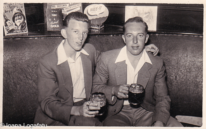 Two friends enjoying drinks in a cozy bar setting