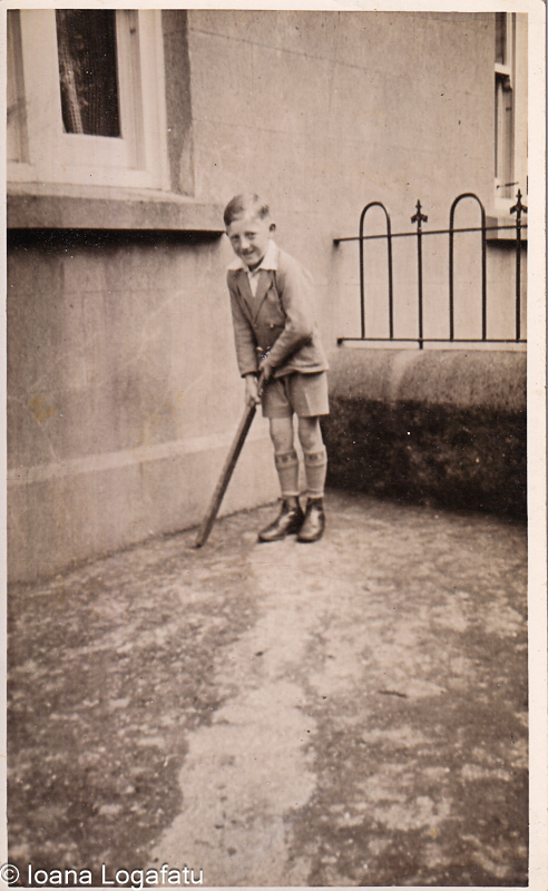Boy happily plays cricket outside