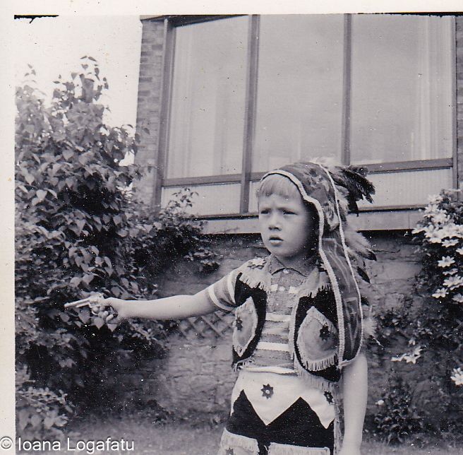 Young child in playful costume pointing outside