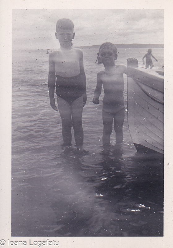 Two boys playing near the water on a summer day