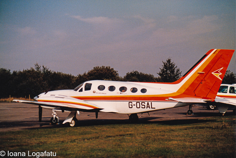 Vintage aircraft parked on the runway at dusk