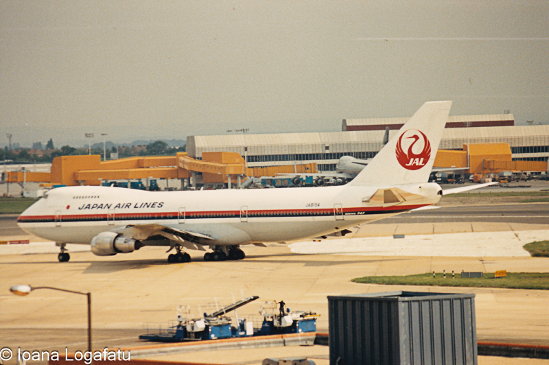 Japan Airlines jet taxiing at a busy airport
