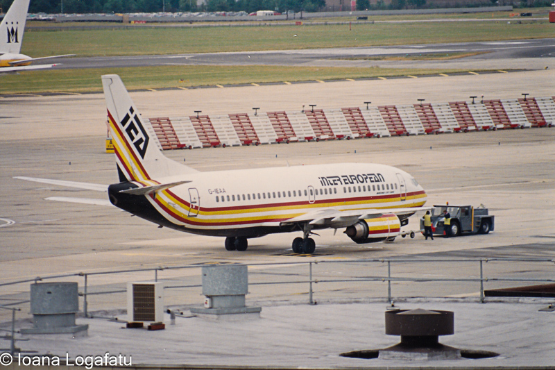 Classic aircraft being serviced at a busy airport