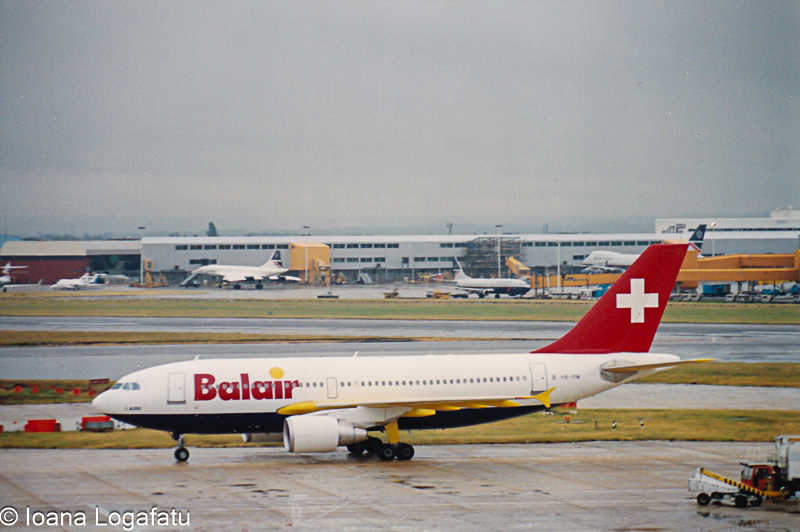 Plane taxiing under gray skies