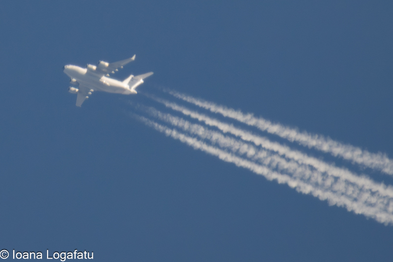 Airplane soaring through a clear blue sky