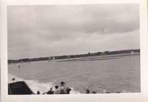 Sailing along the calm waters under gray skies
