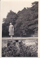 Woman standing gracefully by a serene waterfall