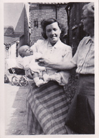 Holding a newborn on a sunny stroll through town