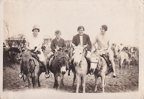 Riding donkeys at a lively fair in the past