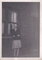 Vintage portrait of a woman by a brick wall