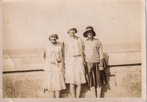 Joyful friends enjoying a sunny day by the sea