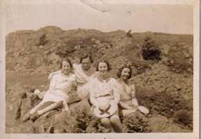Friends enjoying a sunny day on a rocky hillside