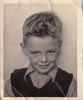 Smiling boy poses for vintage photo
