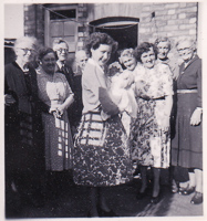 Joyful gathering of women and a baby in sunlight