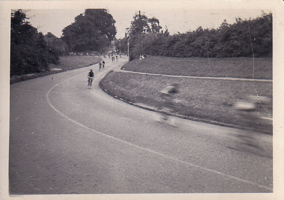 Cyclists racing down a winding path in the park