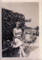 Woman relaxing by lush greenery on a sunny day