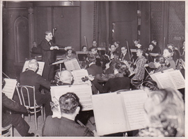Orchestra plays under conductor's guidance