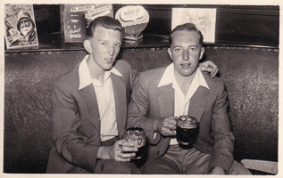 Two friends enjoying drinks in a cozy bar setting