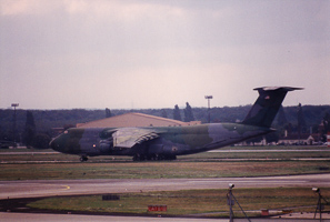 Large cargo aircraft landing at military airfield