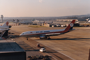 Vintage aircraft taxiing on a busy runway