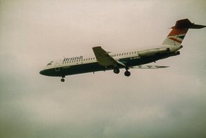 Vintage aircraft glides through cloudy skies