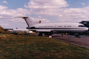 Vintage aircraft parked on a sunny runway