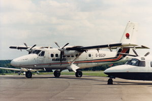 Vintage aircraft on tarmac during sunny day