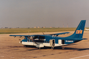 Vintage aircraft on a sunlit tarmac at dusk
