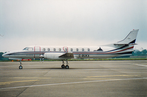 Vintage aircraft parked on runway at airport