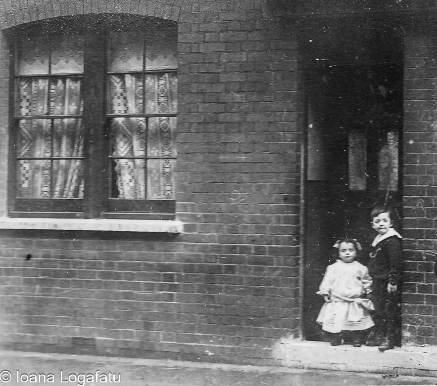 Kids by a doorway in an old neighborhood