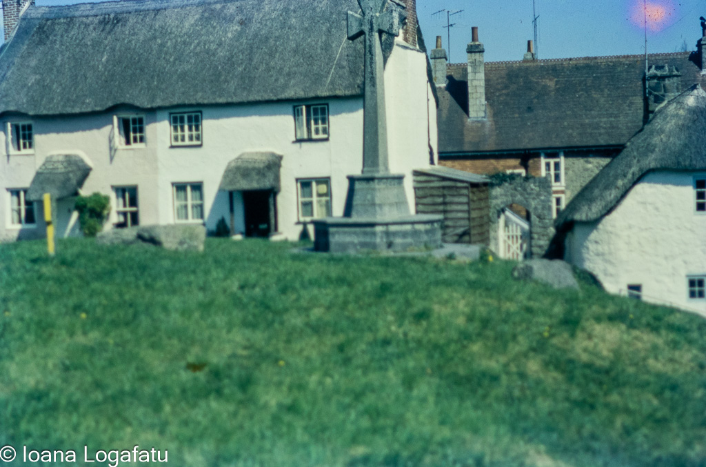 Old village houses beside a stone monument