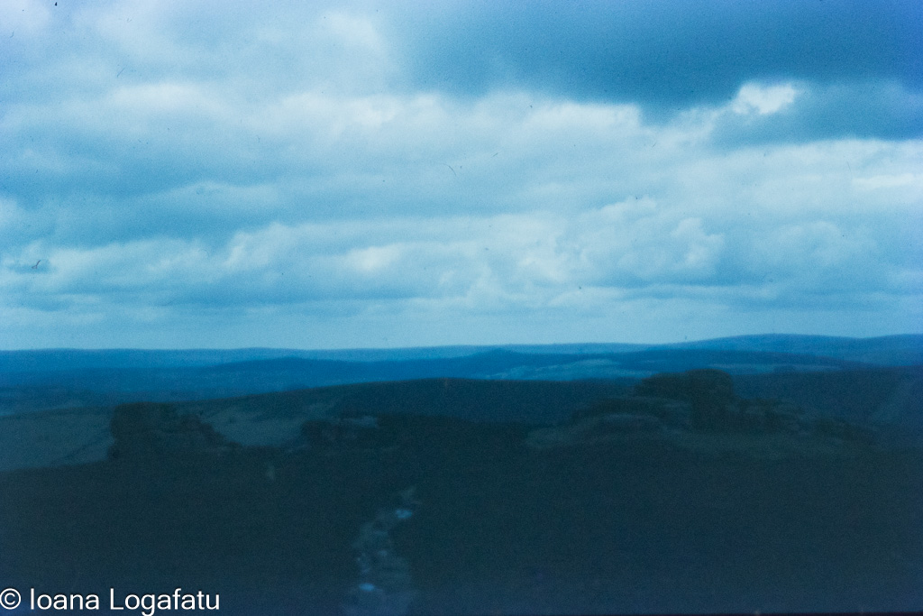 Scenic view of distant mountains under cloudy sky